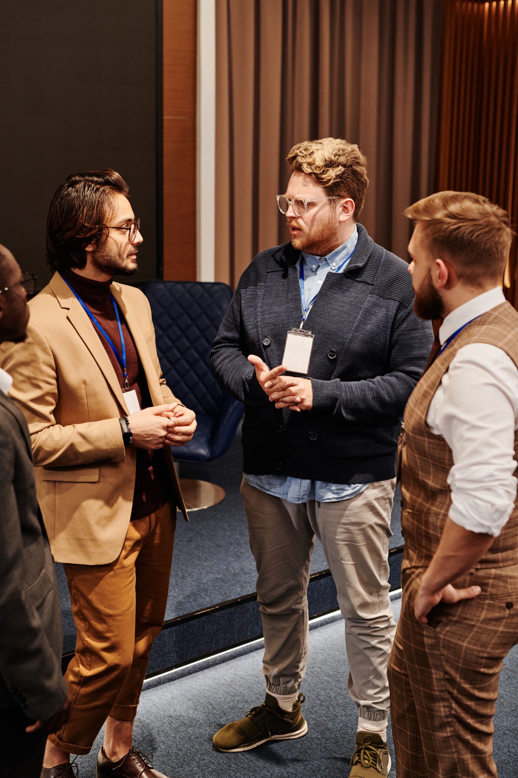Team members greeting conference attendees with a handshake